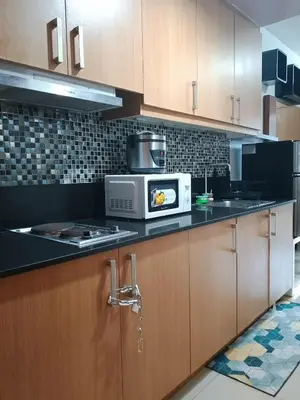 a kitchen with a microwave on a counter at 503-1queen bed 1-pull out 1-sofa bed 1- extra matressedsa view in Manila