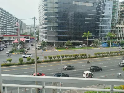a view of a city street with cars and buildings at 503-1queen bed 1-pull out 1-sofa bed 1- extra matressedsa view in Manila