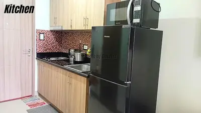 a black refrigerator with a microwave on top of it in a kitchen at Casa Via at Shore 2 Residences inside SM MOA Complex, Pasay City in Manila
