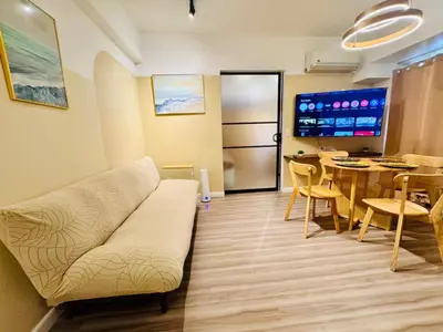 a living room with a couch and a table at Cozy Vibes Retreat in Makati in Manila