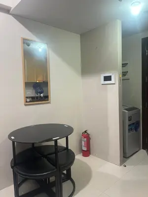 a black table and a stool in a room at One Tree villas - Hyuna Place, Across NAIA T3 in Manila