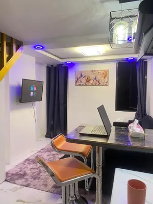 a room with a desk with a laptop on it at Condo apartment in Manila