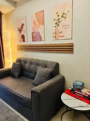 a living room with a couch and a table at Meteoria Staycation in Manila