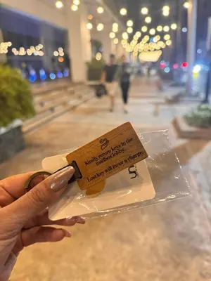 a person holding a piece of food in a bag at Elegant Suite with Balcony l Free wifi and netflix I Across NAIA T3 Airport in Manila