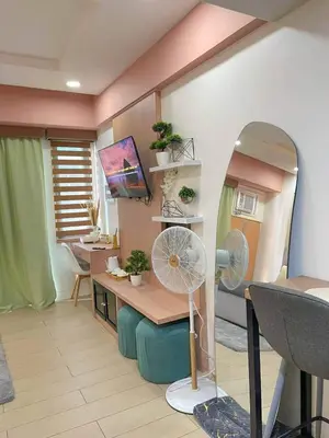 a room with a desk with a fan and a mirror at Elegant Suite with Balcony l Free wifi and netflix I Across NAIA T3 Airport in Manila