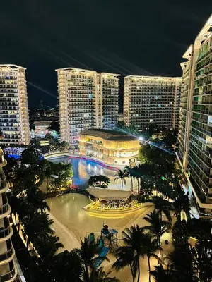 a view of a city at night with tall buildings at Azure Beach View with Balcony PS4 Billiards in Manila
