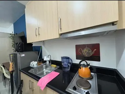 a small kitchen with a sink and a stove at Bernie and Adel's Property Rental in Manila
