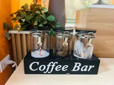 a coffee bar sign with three glass jars on a counter at OYO 1158 Kegama Residences 2 in Cavite