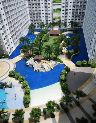 an aerial view of a water park in a city at Cozy 2 Beds Near Mall of Asia in Manila