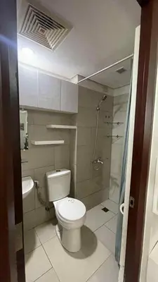 a small bathroom with a toilet and a shower at Alabang homely in Manila