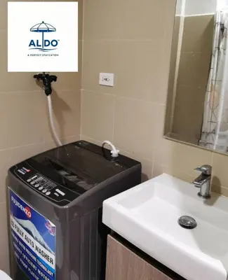 a bathroom with a sink and a trashcan next to a sink at Mall of Asia condotel shore 3 residence Aldo Staycation in Manila