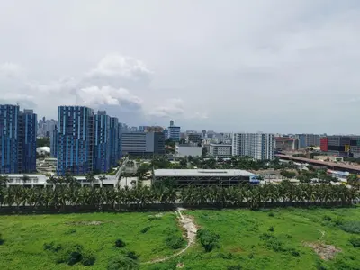 a city with tall buildings and a green field at Mall of Asia condotel shore 3 residence Aldo Staycation in Manila