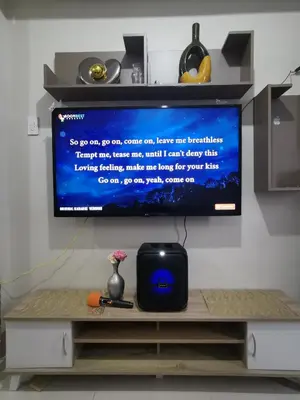 a flat screen tv sitting on top of a table at Mall of Asia condotel shore 3 residence Aldo Staycation in Manila