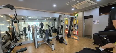 a gym with a bunch of equipment in a room at Affordable Rooms by Rqui Near Airports in Manila