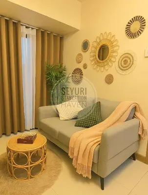 a living room with a couch and a table at Seyuri Staycation Haven in Manila