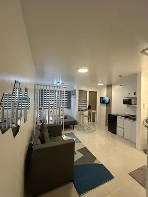 a living room with a couch and a kitchen at Stylish Minimalist Comfort Stay Beside EK in Santa Rosa