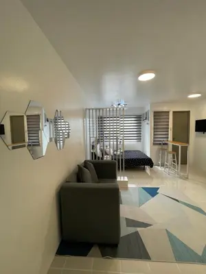 a living room with a couch and a table at Stylish Minimalist Comfort Stay Beside EK in Santa Rosa