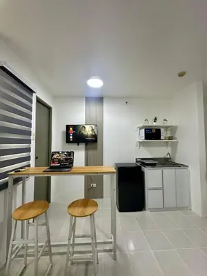 a kitchen with a table and two stools and a counter at Stylish Minimalist Comfort Stay Beside EK in Santa Rosa