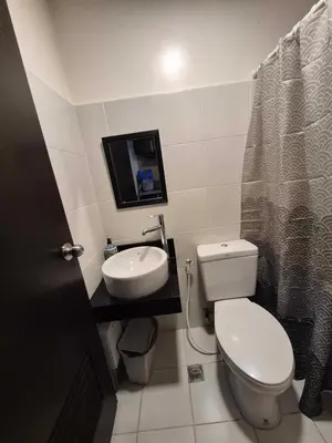 a small bathroom with a toilet and a sink at B&C Studio Kasara Urban Resort Residences in Manila