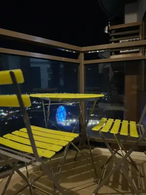 a table and chairs sitting next to a window at Luxury 1BR BayFront Staycation - Free Wi-Fi, Swimming POOL, Near Airport, MOA and PICC in Manila