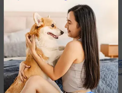 a woman sitting on a bed with a dog at 1Haven in Pasig CCF Bridgetown in Manila