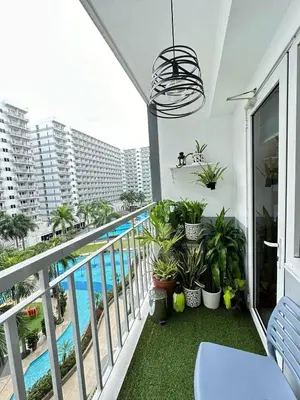a balcony with plants and a swimming pool at Luxury staycation at prime location Mall of Asia Shell Residences Pasay Tower C in Manila