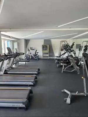 a gym with a bunch of treadms and machines at Light Residence Condo with Pool View in Manila