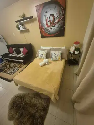 a room with a bed and a chair in it at B&C Studio Kasara Urban Resort Residences in Manila