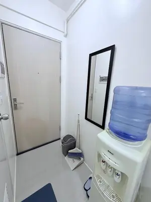 a room with a stack of blue bowls on top of a appliance at Michaels Cozy Retreat in Cubao in Manila