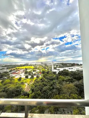 a view of a city under a cloudy sky at Breeze Deluxe moa view 6pax in Manila