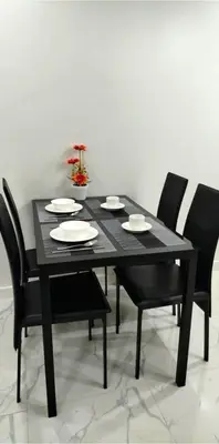 a black dining room table with black chairs and a black table and chairsktop at Modern Minimalist 1BR Condotel at BGC Taguig in Taguig