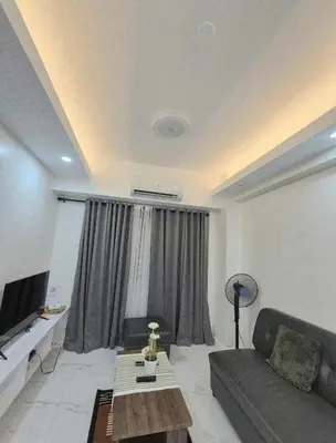 a living room with a couch and a table at Modern Minimalist 1BR Condotel at BGC Taguig in Taguig