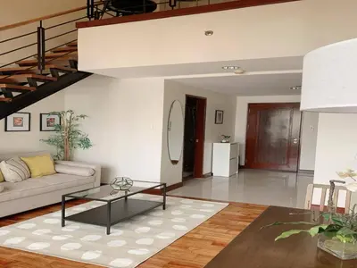 a living room with a couch and a table at Modern Makati Condo for Rent - City Views Convenience in Manila