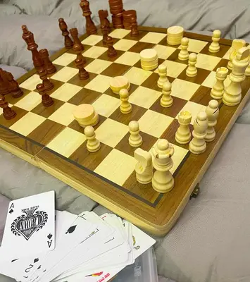 a wooden chess board with chess pieces on it at Balai Sais - Your Scenic Home Away from Home! in Binangonan