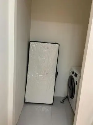 a door in a room with a washing machine at Comfy and Renovated 1 BR with Balcony BGC Golf View in Manila