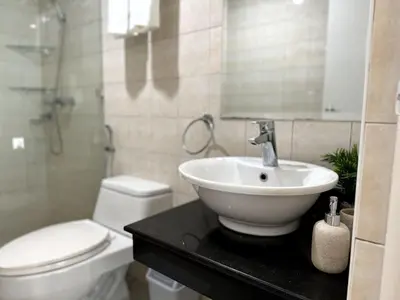 a bathroom with a sink and a toilet at Modern Luxe 3 BR Home BGC in Manila