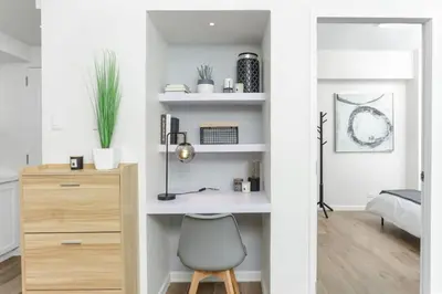 a bedroom with a desk and a chair in a room at Julias Upscale Airy Getaway 1 BR Golf View in Manila