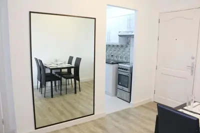 a mirror in a dining room with a table and chairs at Julias Attractive and Cozy Penthouse Golf View in Manila