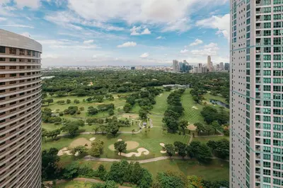 an aerial view of a park between two buildings at Modern Coastal Design 1 BR Condo Golf View BGC in Manila