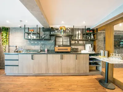a kitchen with wooden cabinets and a counter top at Solace Hotel in Manila