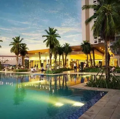 a building with a swimming pool in front of a building at Chelsea Tower by Calvin in Manila