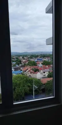 a view of a city from a window at 2BR Mountain View Condo SMDC Charm Metro Manila in Manila