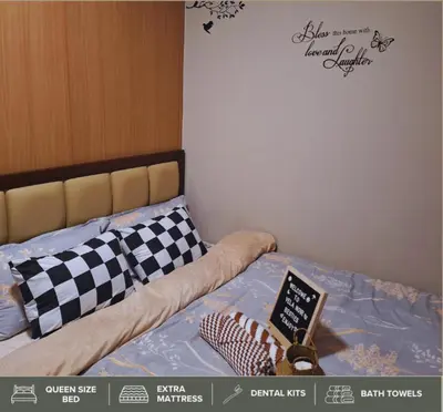 a bedroom with a bed with a sign on it at Shore Residences - Near Mall of Asia in Manila
