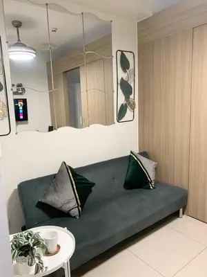 a living room with a couch and a table at Olivia in Manila