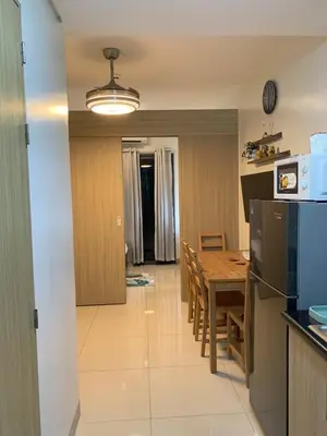 a kitchen and dining room with a table and a refrigerator at Olivia in Manila