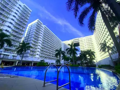 a swimming pool in front of two tall buildings at Azure Staycation - Pablo's Suites in Manila