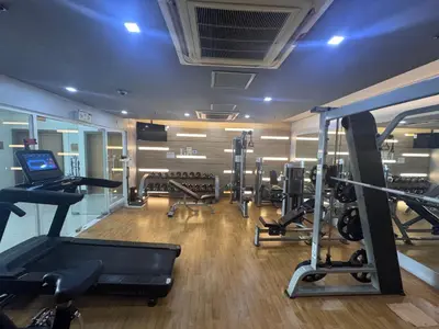 a gym with several treadmills and cardio machines at Cozy Haven - Newport - Walking distance to NAIA T3 in Sampong