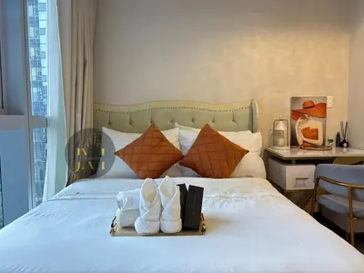a hotel room with a bed with shoes on it at Luxurious & Elegant Unit in Parksuites BGC in Manila