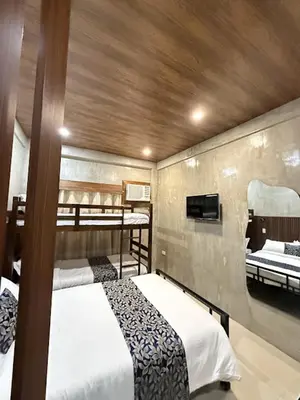two beds in a room with two bunk beds at HM Eco Hotel NAIA in Manila