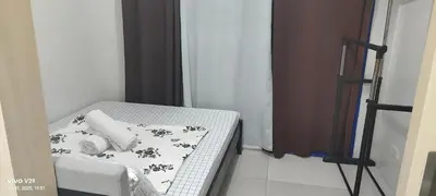 a small bed in a small room with a white and black at Sea Residences LJ Place in Manila